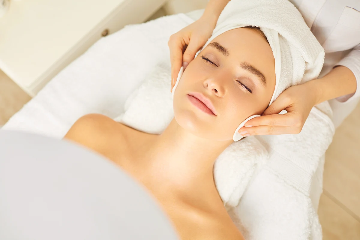 Hypochlorous acid skin cleansing treatment during facial procedure in cosmetic plastic surgery clinic